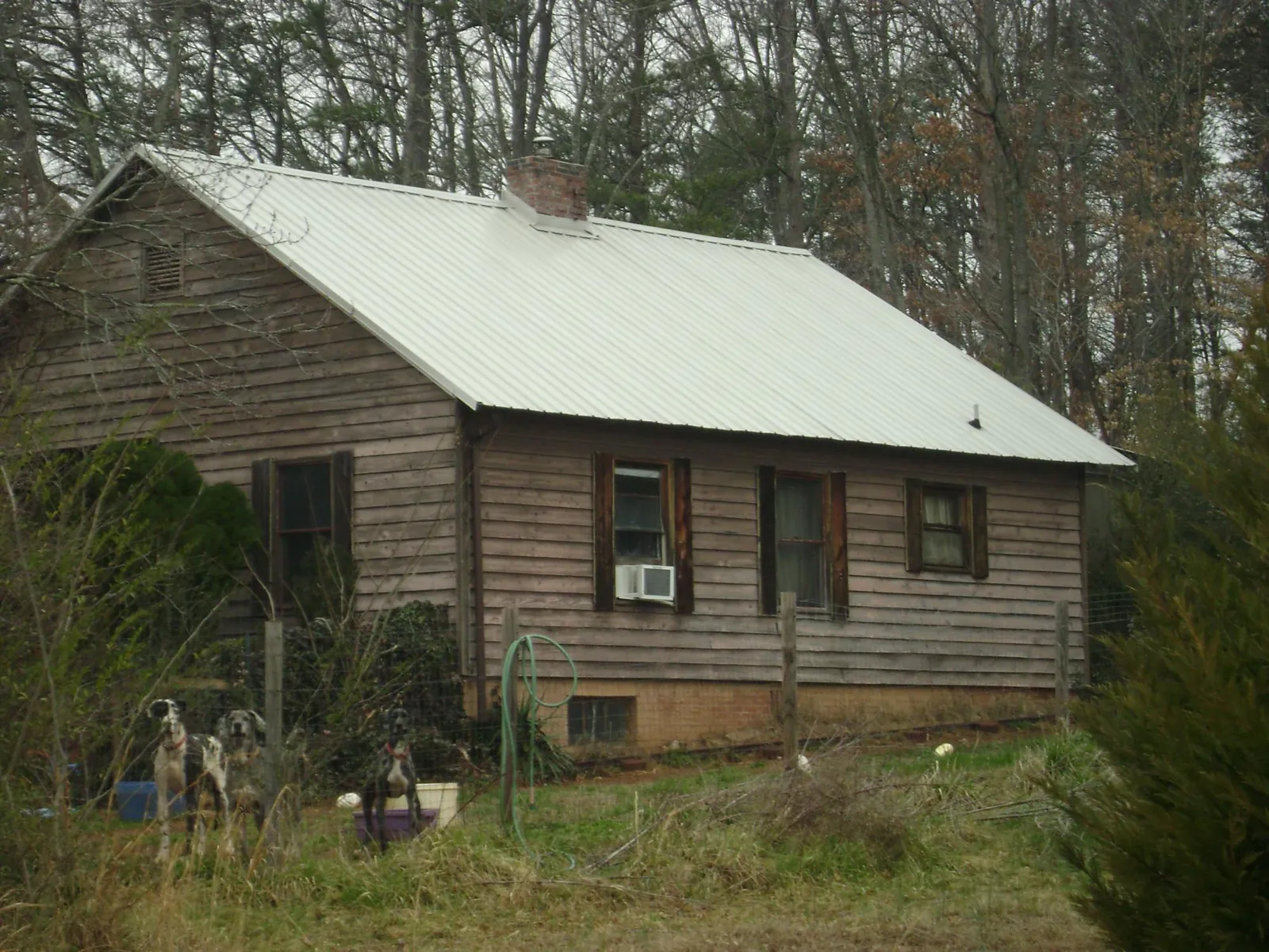 White metal roof on an old wood sided farmhouse, from a Metal Roof Installation job in Goffstown